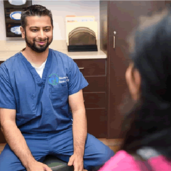 Restore Podiatry & Laser Center - Davinder Bhela, DPM with a patient at Hicksville Podiatry