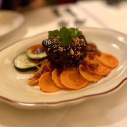 La Petite Grocery - Root beer braised short ribs with spicy cucumbers, carrots, kimchi, and fried peanuts.