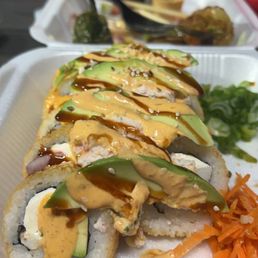 a sushi roll with avocado and sauce a sushi roll with avocado and sauce