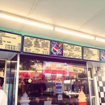 Dairy Delite - a man walking in front of a restaurant - Ice Cream & Frozen Yogurt Near Me - Lakeville, Minnesota