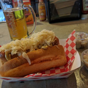 Kluddes Kitchen + Bar - Bratwurst with dijon, raw onions and sauerkraut, double potato salad for sides and a krombacher pilsner...perfect combo. - Gastropubs Near Me - Redlands, California Kluddes Kitchen + Bar - Bratwurst with dijon, raw onions and sauerkraut, double potato salad for sides and a krombacher pilsner...perfect combo. - Gastropubs Near Me - Redlands, California