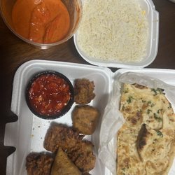 Rose Garden Indian Cuisine - Butter chicken, rice, garlic naan, vegetable platter, and onion chutney