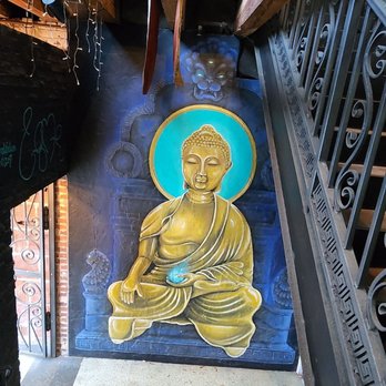 Indochine - a painting of a buddha on a wall - Thai Near Me - Jacksonville, Florida