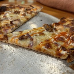 two slices of pizza on a metal tray two slices of pizza on a metal tray