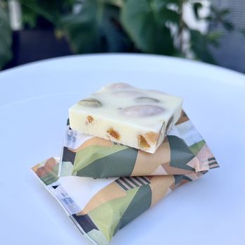 Läderach chocolatier suisse - White chocolate with almonds, pistachios, orange - Chocolatiers & Shops Near Me - Santa Clara, California Läderach chocolatier suisse - White chocolate with almonds, pistachios, orange - Chocolatiers & Shops Near Me - Santa Clara, California