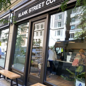 Blank Street Coffee - a man sitting on a bench in front of a coffee shop - Coffee & Tea Near Me - New York, New York Blank Street Coffee - a man sitting on a bench in front of a coffee shop - Coffee & Tea Near Me - New York, New York