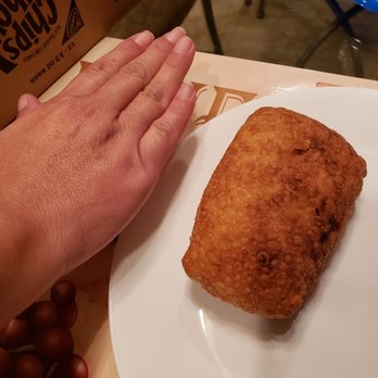 Hing Hing Kitchen - My wife's hand next to egg roll.  Massive - Chinese Near Me - Lindenhurst, New York