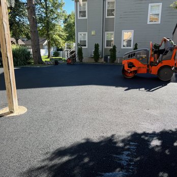 WB Paving - a road being paved with asphalt - General Contractors Near Me