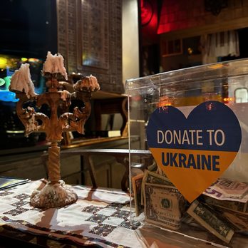 Tryzub Ukrainian Kitchen - Donation box for Ukraine and striking candleholder with some burnt candles. - Ukrainian Near Me - Chicago, Illinois