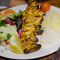 Ariana Restaurant - Portions of marinated whole poussin, charcoal grilled, served with saffron steamed basmati rice and grilled tomato mixed vegetable