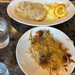 Biscuits and sausage gravy with a side of loaded hash browns.