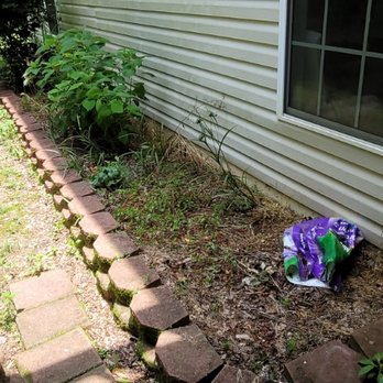 Adam's Yardscapes - a flower bed in front of a house - Lawn Services Near Me