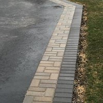GM Landscape - a driveway with a brick border - Tree Services Near Me
