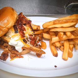 595 Tiki Bar & Grill - Chili Burger, a 4oz smashed burger topped with homemade chili, french fries, sour cream, shredded cheese and bacon.