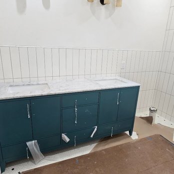 Rubber Duck Refinishing - Tub sits to the right side, but tile wraps the whole bathroom. Lucky I already had the vanity covered before the tub was refinished. - Refinishing Services Near Me - Round Rock, Texas