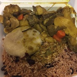 Curry goat, rice and peas, and boiled dumpling