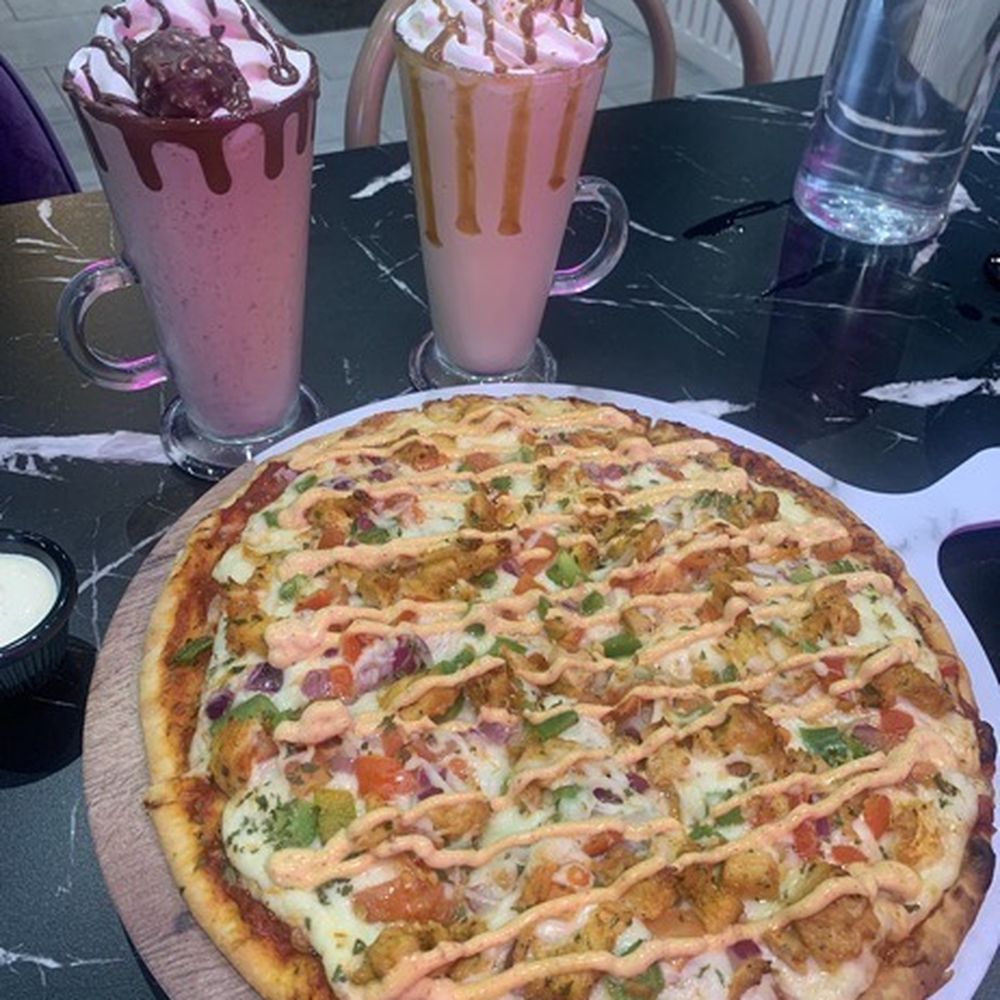 Peri peri chicken pizza and Ferrero rocher milkshake and the biscoff milkshake Peri peri chicken pizza and Ferrero rocher milkshake and the biscoff milkshake