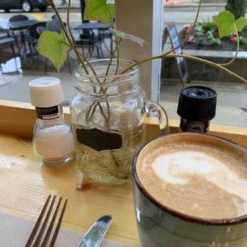 First Bite - Small almond milk latte and their little table plants - Breakfast & Brunch Near Me - Ann Arbor, Michigan