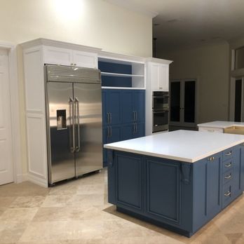 Mills Construction & Management - a kitchen with blue cabinets and stainless steel appliances - General Contractors Near Me - Waterbury, Connecticut Mills Construction & Management - a kitchen with blue cabinets and stainless steel appliances - General Contractors Near Me - Waterbury, Connecticut