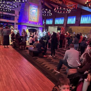 Great Wolf Lodge - Lobby story time - The image shows a busy indoor lobby area decorated for Halloween, with a large crowd of adults and children gathered around a stage. The decor includes Halloween-themed banners and lighting, with a prominent  - Resorts Near Me - Mashantucket, Connecticut
