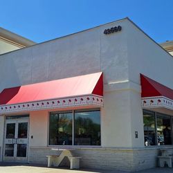 This is the exterior of the restaurant. The trademark crossed palms are to the left.