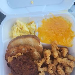 Lama's Kitchen and Seafood Market - Scrambled eggs, cheese grits, salmon pattie and fried counch strips.