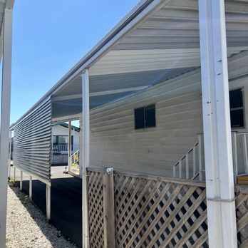 Mobile Home Improvement - Back view of neighbors completed replaced/repaired carport - Mobile Home Repair Near Me