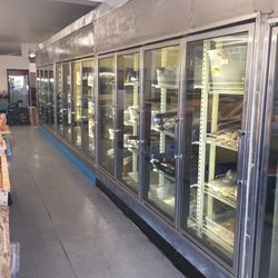 Makola African Market - Freezer section of traditional West African food items. Stock fish, chicken, beef, goat, fish, tripe, okra, etc.