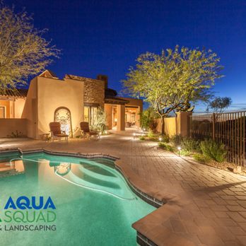 Aqua Squad Pools & Landscaping - Custom swimming pool with professional landscape lighting for a warm, inviting backyard at night. - Pool Cleaners Near Me - Mesa, Arizona Aqua Squad Pools & Landscaping - Custom swimming pool with professional landscape lighting for a warm, inviting backyard at night. - Pool Cleaners Near Me - Mesa, Arizona
