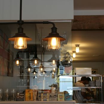 Fish and Sips - Lighting over booths and, past the glass, a glimpse into the open kitchen - Fish & Chips Near Me - Collingwood, Ontario Fish and Sips - Lighting over booths and, past the glass, a glimpse into the open kitchen - Fish & Chips Near Me - Collingwood, Ontario