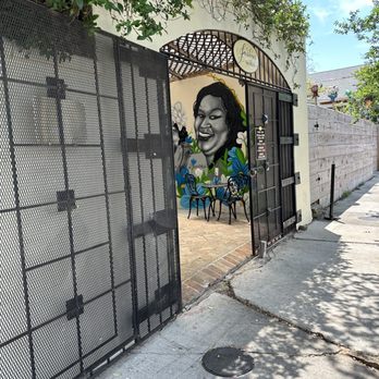 JusTini’s - a mural of a woman's face on the side of a building - Seafood Near Me - New Orleans, Louisiana JusTini’s - a mural of a woman's face on the side of a building - Seafood Near Me - New Orleans, Louisiana