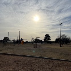 Newman Park - Monkey bars, slide, climbing structure, and swings