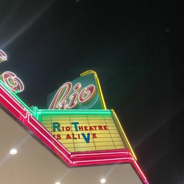 Name of establishment in neon letters "Rio Theater" Name of establishment in neon letters "Rio Theater"
