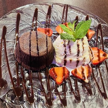 Mojitos Latin Cuisine - Chocolate lava cake served with vanilla ice cream and fresh strawberries. - Latin American Near Me - Hamden, Connecticut Mojitos Latin Cuisine - Chocolate lava cake served with vanilla ice cream and fresh strawberries. - Latin American Near Me - Hamden, Connecticut