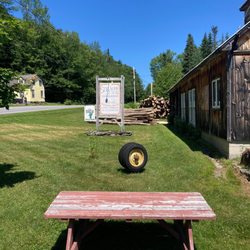 Sprague & Son Sugarhouse - Sign and picnic table outside sugar house