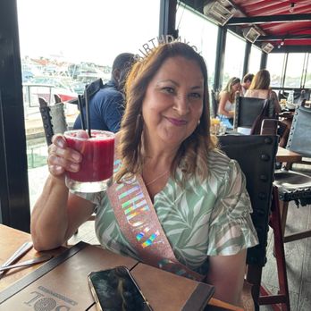 SOL Mexican Cocina - Birthday girl drinking her cocktail. - Mexican Near Me - Newport Beach, California SOL Mexican Cocina - Birthday girl drinking her cocktail. - Mexican Near Me - Newport Beach, California