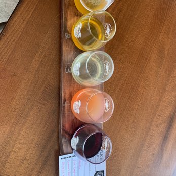 Ambrosia Orchard - a row of wine glasses on a wooden table - Cideries Near Me - Hoagland, Indiana Ambrosia Orchard - a row of wine glasses on a wooden table - Cideries Near Me - Hoagland, Indiana