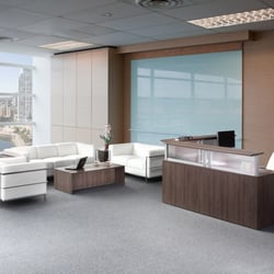 E3 Office Furniture & Interiors - Reception Desk in Modern Walnut with Contemporary Soft Seating in White Leathertek.