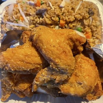 Fried Crispy Chicken - House Fried Rice and Chicken - A takeout container holds three pieces of fried chicken with a golden-brown, crispy coating. Behind the chicken, there is a portion of fried rice mixed with diced carrots, peas, bean sprouts, and small pieces of meat. The food is presented in a white, plastic, hinged container, typical for casual dining or takeout orders. - Chicken Shop Near Me - Union, New Jersey