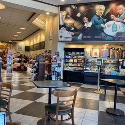 A view of the cafe area with a news stand in the background. A view of the cafe area with a news stand in the background.