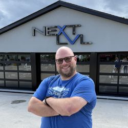 Next LVL Auto Sales - Dirk Hicks standing in front of Next LVL Auto