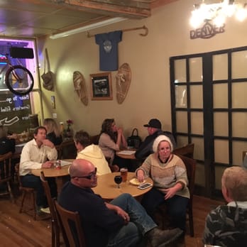 Dakota Shivers Brewing - a group of people sitting around a table - Breweries Near Me - Lead, South Dakota