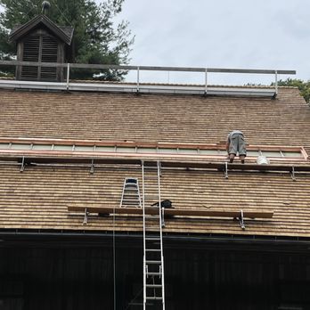 Royal Contracting - two men on a roof working on a roof - General Contractors Near Me - Dedham, Massachusetts Royal Contracting - two men on a roof working on a roof - General Contractors Near Me - Dedham, Massachusetts