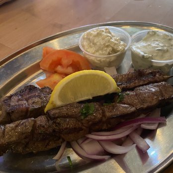 Greek Belly - Lamb kabobs with sliced lemons , tomatoes , and the 2 sauces. Spicy feta was sooo good , and the Tzatziki was super fresh. - Mediterranean Near Me - Springfield, Missouri Greek Belly - Lamb kabobs with sliced lemons , tomatoes , and the 2 sauces. Spicy feta was sooo good , and the Tzatziki was super fresh. - Mediterranean Near Me - Springfield, Missouri