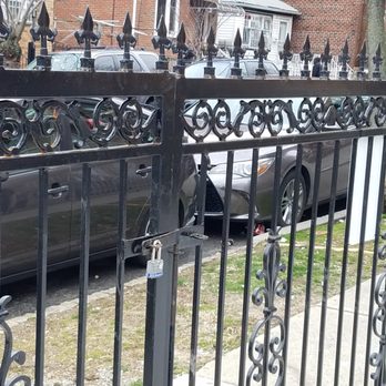 Ironwork NYC - Here's the fixed alignment of the two driveway gate doors with the locking latch that goes into the ground.  They totally fixed it all! - Metal Fabricators Near Me - Long Island City, New York
