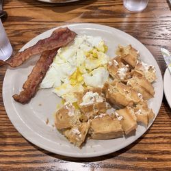 Lion's Pride Restaurant - Half a Belgium Waffle with Over Medium Eggs & Bacon (well done)