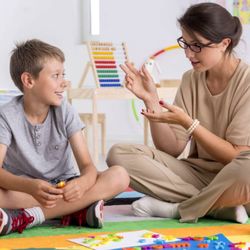 Fairfax Pediatric Therapy - A young boy engaging in a speech therapy session with a therapist, working on communication skills through interactive activities.