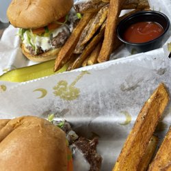 Eileen’s Cafe at Wyboo - Vinn's Burger   1/3 pound House ground brisket patty with melted white American served on potato bun with lettuce, tomato, onion & pickle