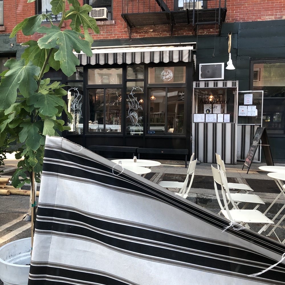 Baba Cool - a black and white striped umbrella on a street corner - New American Near Me - Brooklyn, New York