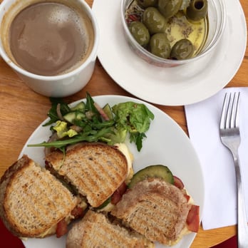 Munson's Coffee & Eats - Chilli Halloumi and Hummus on dark bread, toasted. Queen olive, sundried tomato and artichoke pot. Americano. - Coffee & Tea Near Me - London, XGL Munson's Coffee & Eats - Chilli Halloumi and Hummus on dark bread, toasted. Queen olive, sundried tomato and artichoke pot. Americano. - Coffee & Tea Near Me - London, XGL